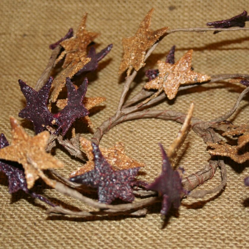 This candle ring is 2 1/2 inches in the center. The star branches can 